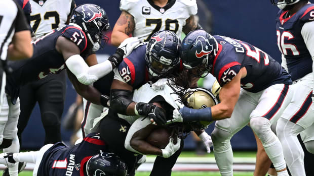 Oct 15, 2023; Houston, Texas, USA; Houston Texans defensive tackle Sheldon Rankins (98), linebacker Blake Cashman (53), safety Jimmie Ward (1) and defensive end Will Anderson Jr. (51) bring down New Orleans Saints running back Alvin Kamara (41) during the fourth quarter at NRG Stadium. Mandatory Credit: Maria Lysaker-USA TODAY Sports